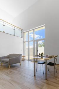 a living room with a table and a couch at Résidence Penaud - Appartements design et climatisés à la campagne in Saulcet