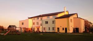 a large building with a playground in front of it at Noclegi nad Biebrzą Stara Szkoła in Wroceń
