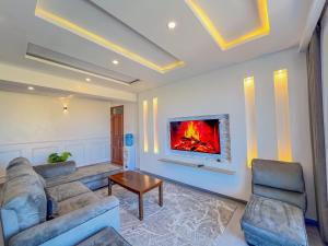 a living room with a couch and a fireplace at Blue Reef Holiday Home in Mombasa
