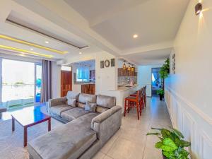 a living room with a couch and a table at Blue Reef Holiday Home in Mombasa