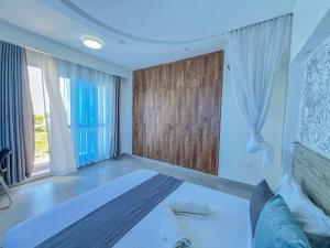 a bedroom with a large bed and a large window at Blue Reef Holiday Home in Mombasa +32 photos