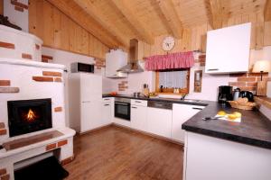 a kitchen with a fireplace and a stove at Almchalet Schneeberg in Mühlbach am Hochkönig