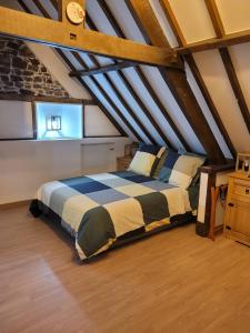 a bedroom with a large bed in a attic at Holidays-Normandy - Ursula gîte 