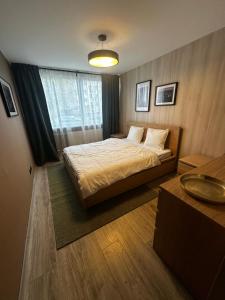 a bedroom with a bed and a sink in it at City Center Hostel in Mažeikiai +9 photos