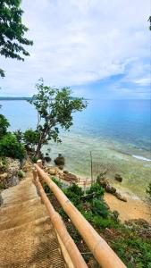 a view of the ocean from a wooden rail at Tez's Backpacking Lodge in Maria +26 photos