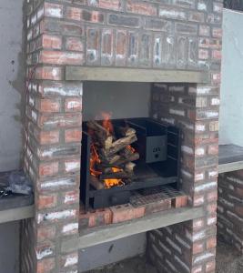 a brick oven with a fire in it at Peace Lily Garden Cottage in George