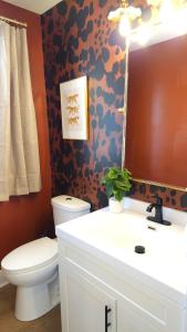 The Funky Fun Haus - Pickleball, Hot Tub, Arcade في كولومبوس: حمام مع مرحاض ومغسلة ومرآة