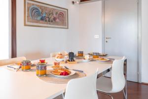 ein Tisch mit Tellern voller Essen darauf in der Unterkunft Centralissimo vista Municipio, Elegante con Rooftop in Pordenone + 11 Fotos