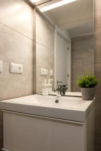 a bathroom with a sink and a mirror at GoToSeville FERIA APARTMENTS in Seville