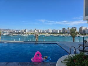 a swimming pool with two toys in the water at Superbe appartement à marina Tanger in Tangier