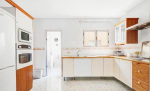 a kitchen with white cabinets and a sink at wonderful tila house, facing the sea in La Garita