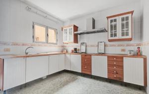 a kitchen with white cabinets and a sink at wonderful tila house, facing the sea in La Garita +7 photos