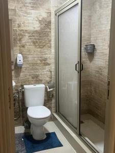 a bathroom with a toilet and a shower at avenue hassan 2 agadir in Oulad Akkou