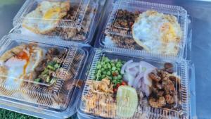 four plastic containers filled with different types of food at Supunpong Pool Villa in Nakhon Nayok