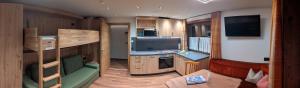 a small room with a kitchen and a living room at Ferienwohnungen Annelies in Tux