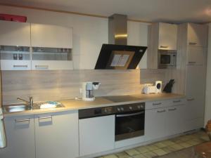 a kitchen with white cabinets and a sink at Alte Kirchstraße in Willingen