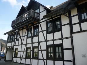 a black and white building with a balcony at Alte Kirchstraße in Willingen