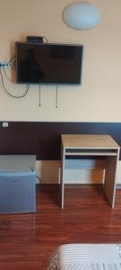 a room with a desk and a tv on a wall at Hotel Marko 2 Warszawa in Warsaw +25 photos