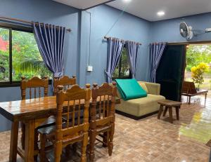 a living room with a table and a couch at Nadia Resort Kohjum in Ko Jum