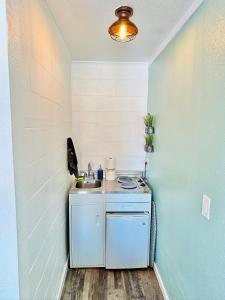 a small kitchen with a sink in a room at Studio with a kitchenette in an updated motel in Basse-Terre