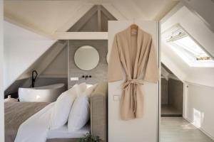 a master bedroom with a bed and a bath tub at Tovve Loft in Schagen +10 photos