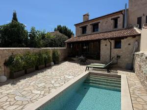 a house with a swimming pool in front of a house at El Águila Real in Valdeprados