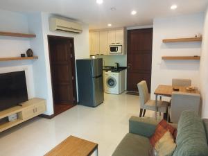 a living room with a couch a table and a kitchen at Arisara Nest in Bophut 