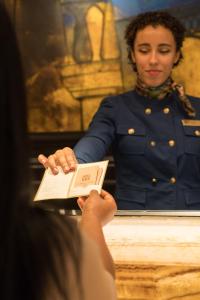a woman in uniform reading a book at St. James' Court, A Taj Hotel, London in London +109 photos