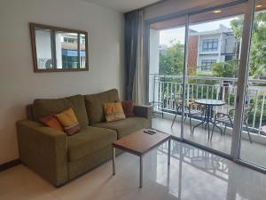 a living room with a couch and a balcony at Arisara Nest in Bophut 