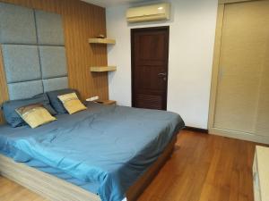 a bedroom with a bed with blue sheets and a door at Arisara Nest in Bophut  +6 photos