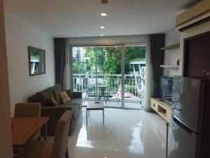 a living room with a couch and a table at Arisara Nest in Bophut 