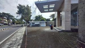 a person on a scooter parked next to a building at Pondok Agung Rubicon in Yogyakarta