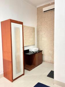 a mirror in a room with a desk with a sink at Pondok Agung Rubicon in Yogyakarta +18 photos