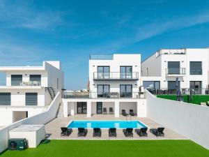 an exterior view of a house with a swimming pool at Villa Zen with sea view and private pool in Lourinhã
