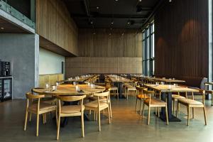 a dining room with wooden tables and chairs at Hotel Loa in Hvolsvöllur