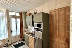 アラスにあるL'atelier Arrageois - 55m2 6 persの緑色の冷蔵庫とドアのあるキッチン