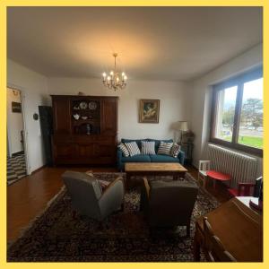 a living room with a blue couch and chairs at Le Bellevue 2 in Thonon-les-Bains