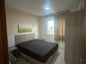 a small bedroom with a bed and a window at PRIVÉ RIVIERA PARK Apto Hotel in Caldas Novas +46 photos