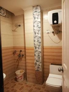 un baño con inodoro y ducha en Airport Hotel Annexe, Complimentory Pickup or Drop, en Nueva Delhi