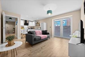 a living room with a couch and a kitchen at Stylish & Spacious 3BR 3Bath with Private Parking, WiFi, Smart TVs in Spon End +15 photos