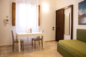 a room with a table and chairs and a bed at San Domenico Residence by BADIA NUOVA in Trapani +83 photos
