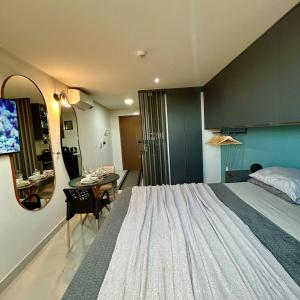 a bedroom with a large bed and a table and a mirror at Flat com vista linda para o mar! in Cabedelo +27 photos