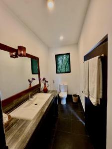 a bathroom with a sink and a toilet at Sundaras Family Suites in Dambulla