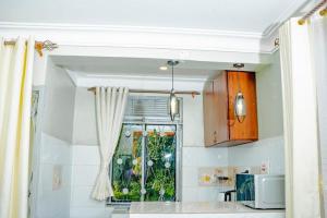 a kitchen with a window and a kitchen counter at BougainVille in Fort Portal