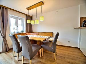 a dining room with a wooden table and chairs at Am Bruckenstüberl in Schönau am Königssee