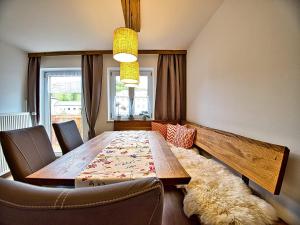 a dining room with a wooden table and chairs at Am Bruckenstüberl in Schönau am Königssee