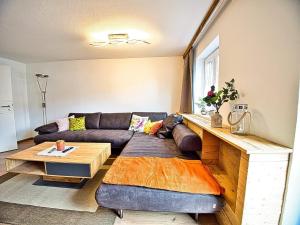 a living room with a couch and a table at Am Bruckenstüberl in Schönau am Königssee