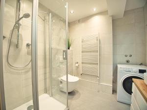 a bathroom with a toilet and a walk in shower at Ferienwohnung Bergliebe in Berchtesgaden +4 photos