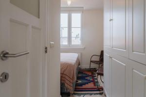a bedroom with a bed and a window and a door at Cozy Apartment in Central Antwerp in Antwerp