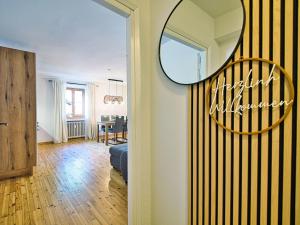 a living room with a mirror on a wall at Ferienwohnung Faes in Berchtesgaden